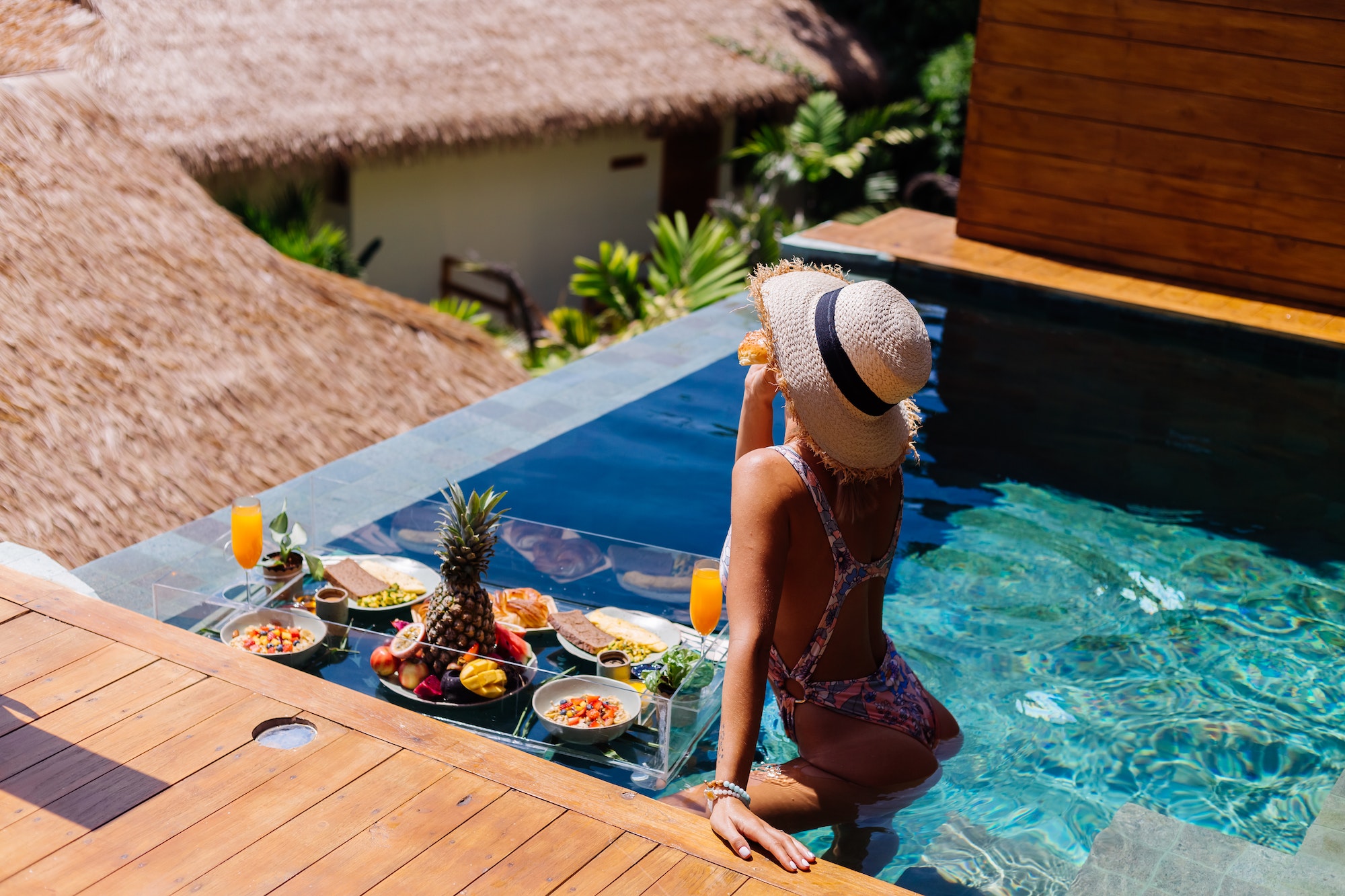 woman-in-bikini-and-straw-hat-with-floating-breakfast-at-amazing-luxury-bali-style-villa.jpg
